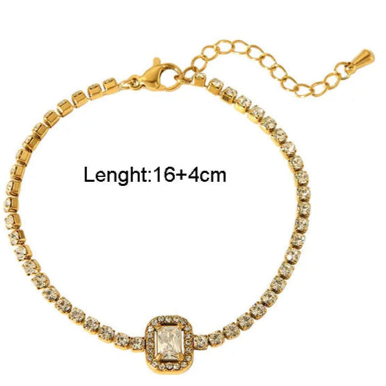 Gold bracelet with diamond-like stones on a white background