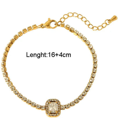 Gold bracelet with diamond-like stones on a white background